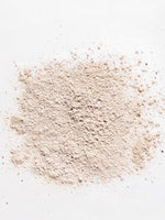 Powdered non-toxic dry shampoo on a white background, perfect for natural hair care from Primally Pure.