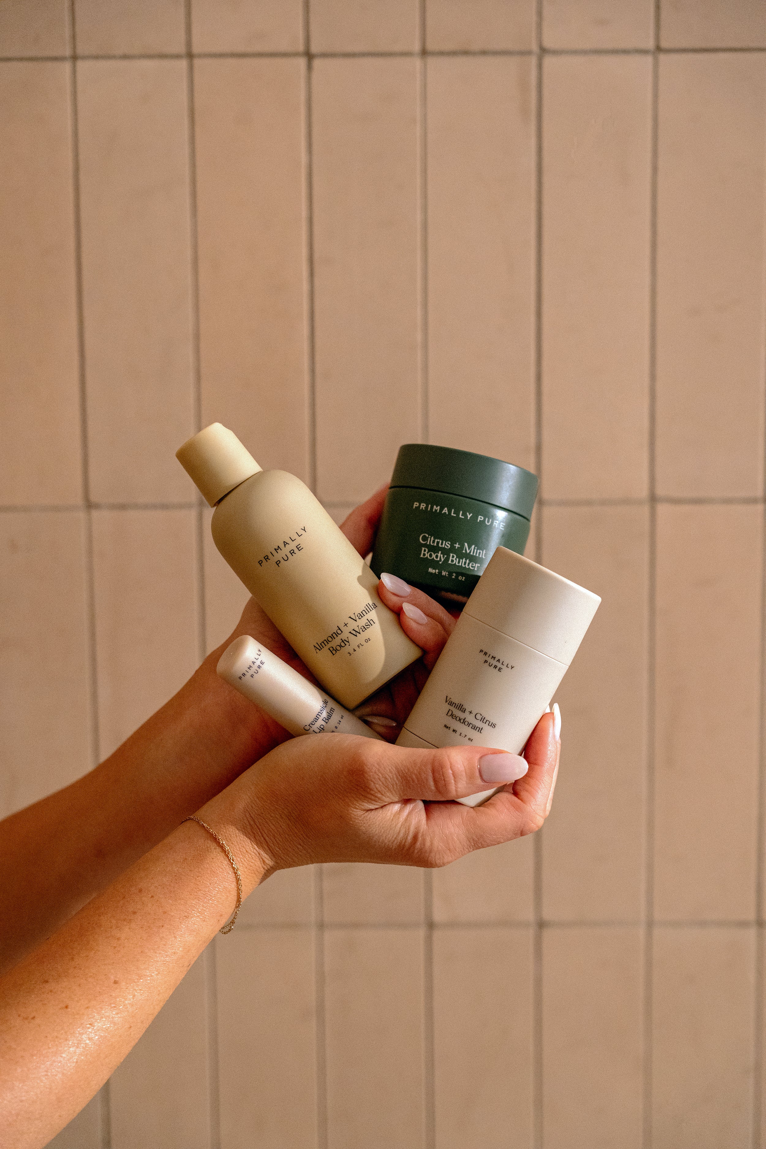 Woman holding Primally Pure products included in The Jet Set bundle