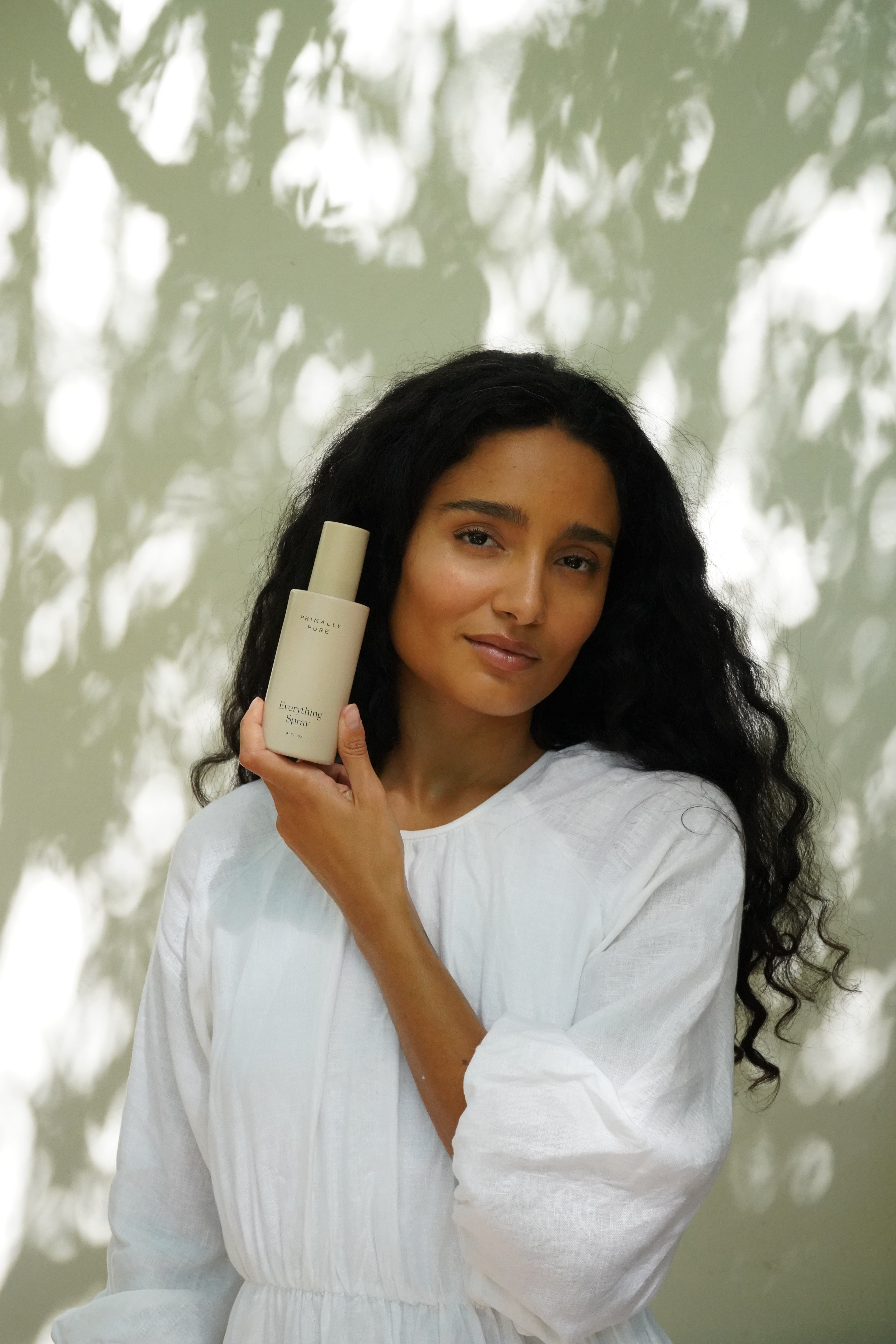 Woman holding Primally Pure Everything Spray