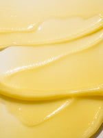 Close-up of a yellow tallow balm swirled on a surface.