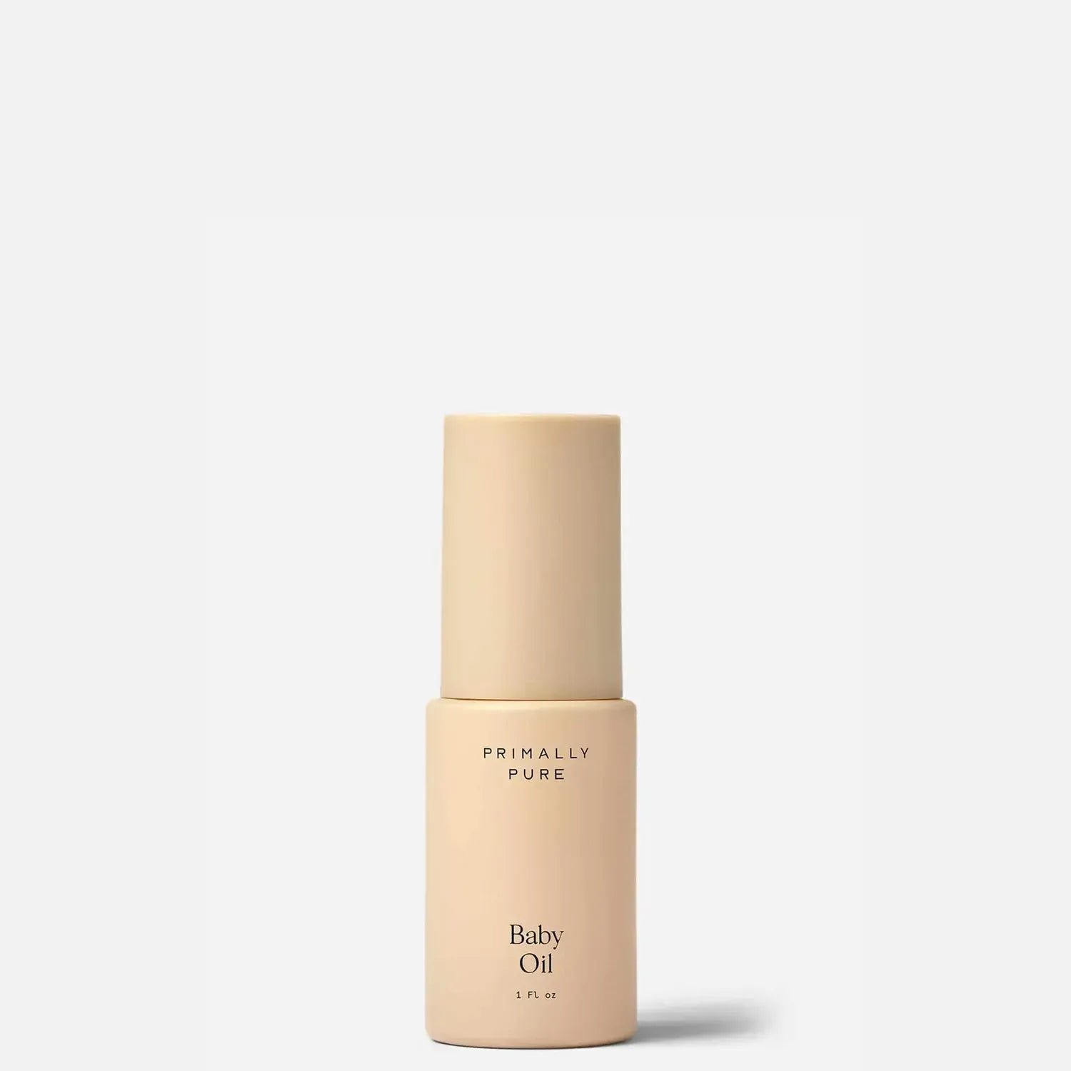 Primally Pure Baby Oil in a minimalist beige bottle with a matching cap, centered on a clean white background.