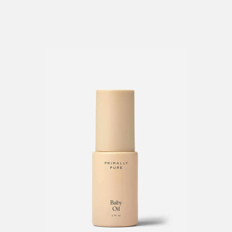 Primally Pure Baby Oil in a minimalist beige bottle with a matching cap, centered on a clean white background.