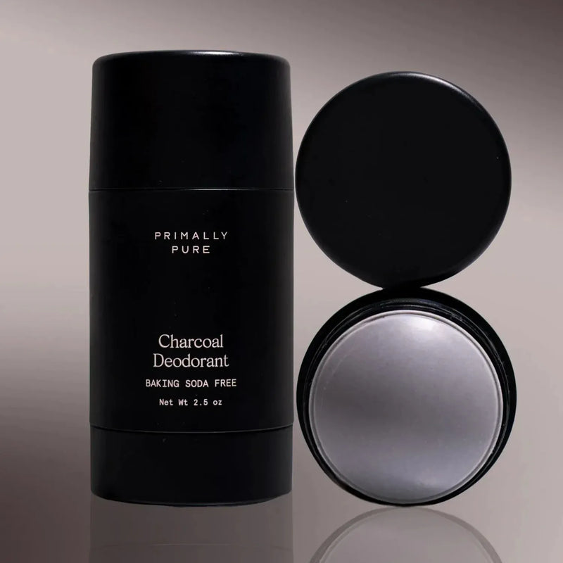 Primally Pure Charcoal Deodorant (Baking Soda Free) Deodorant Primally Pure stick shown closed next to its open round container, both in black packaging on a neutral gray background.