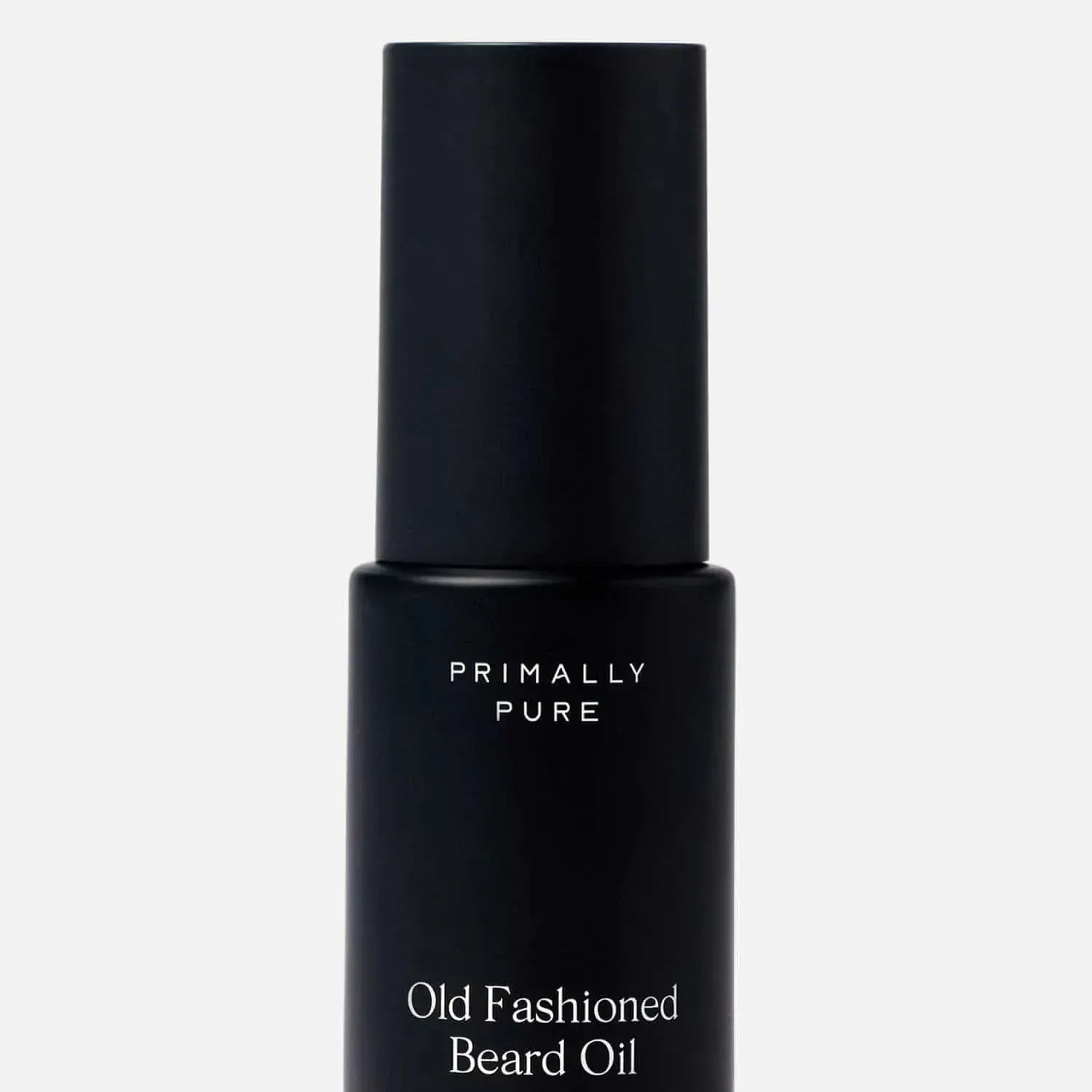 Black bottle of Primally Pure Old Fashioned Beard Oil on a white background