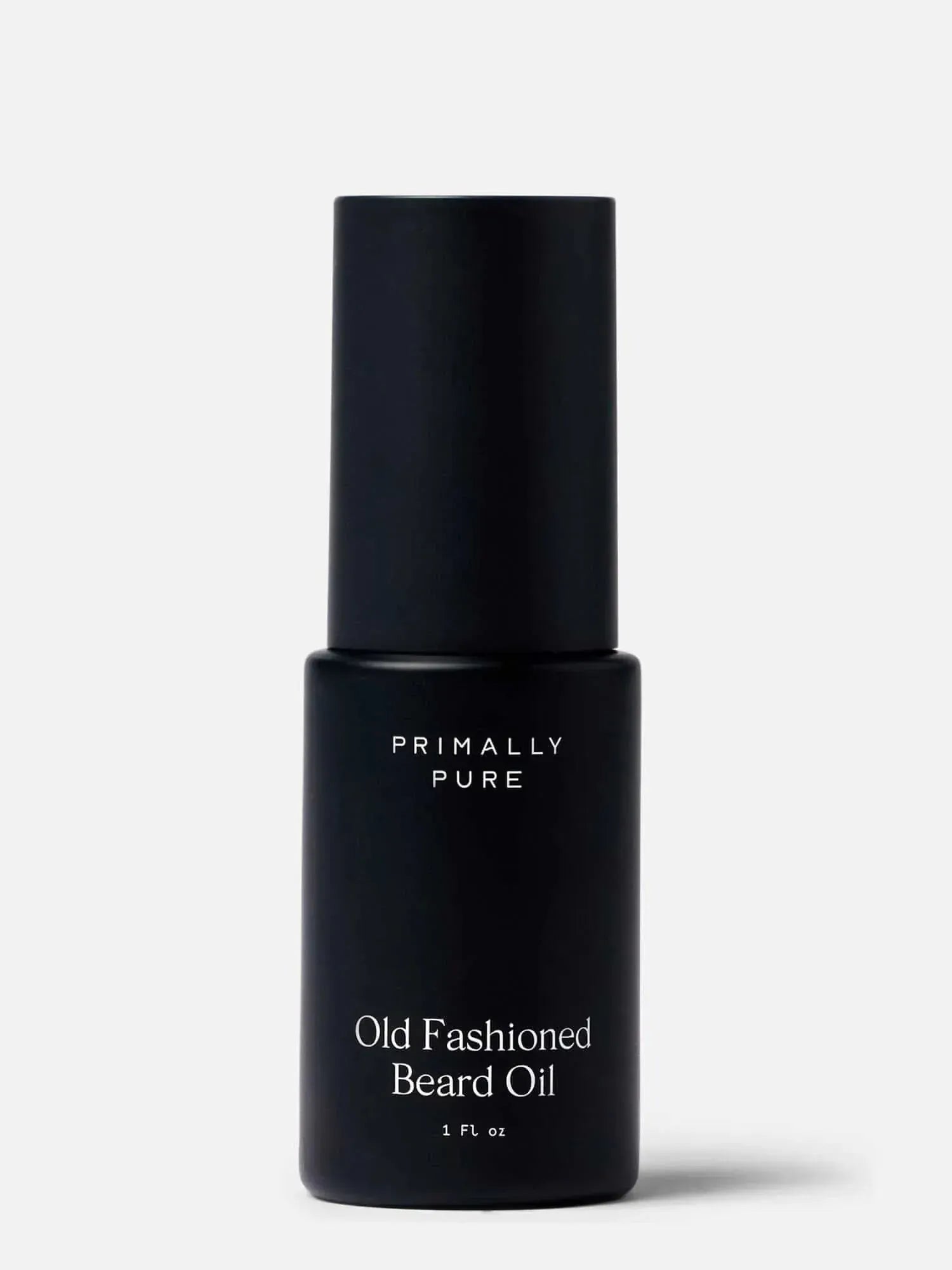 Black bottle of Primally Pure Old Fashioned Beard Oil on a white background