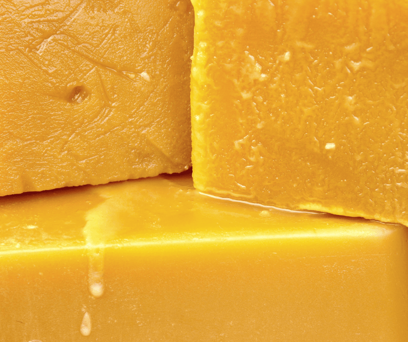 Golden yellow beeswax blocks used in natural skincare products.