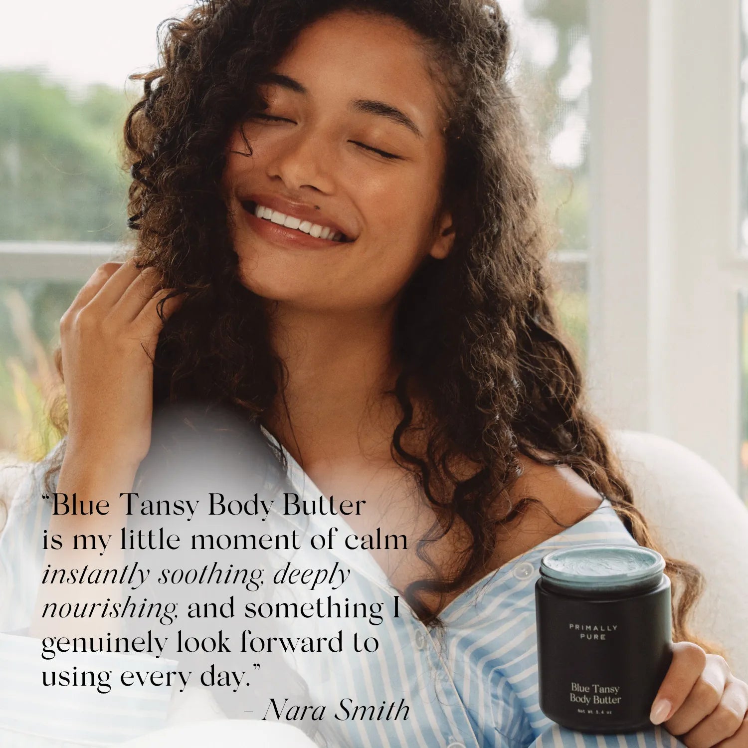 A woman with curly dark hair smiles while holding a jar of Priority Pure Blue Tansy Body Butter. She is wearing a light blue and white striped shirt, and the image includes a quote overlay from Nara Smith.