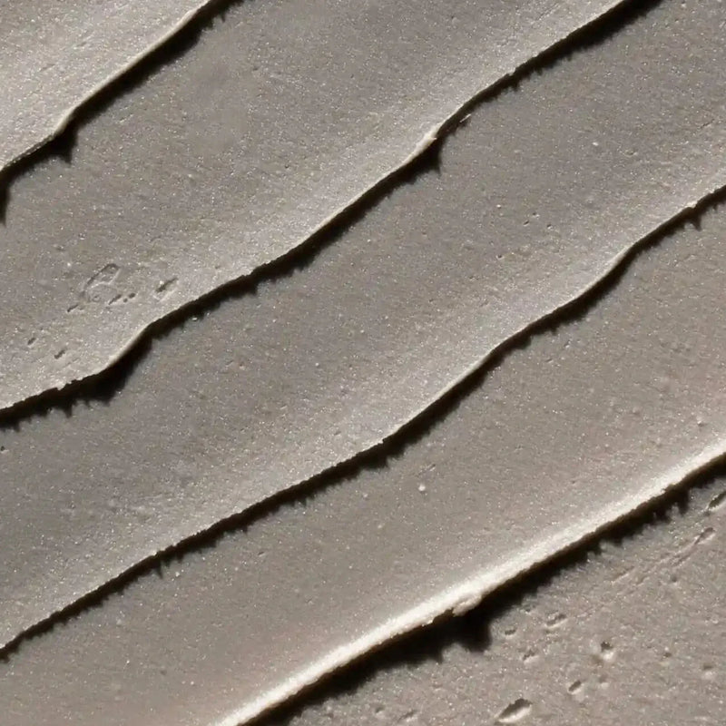 Close-up texture of charcoal deodorant showcasing smooth application lines, highlighting the benefits of deodorant with charcoal.
