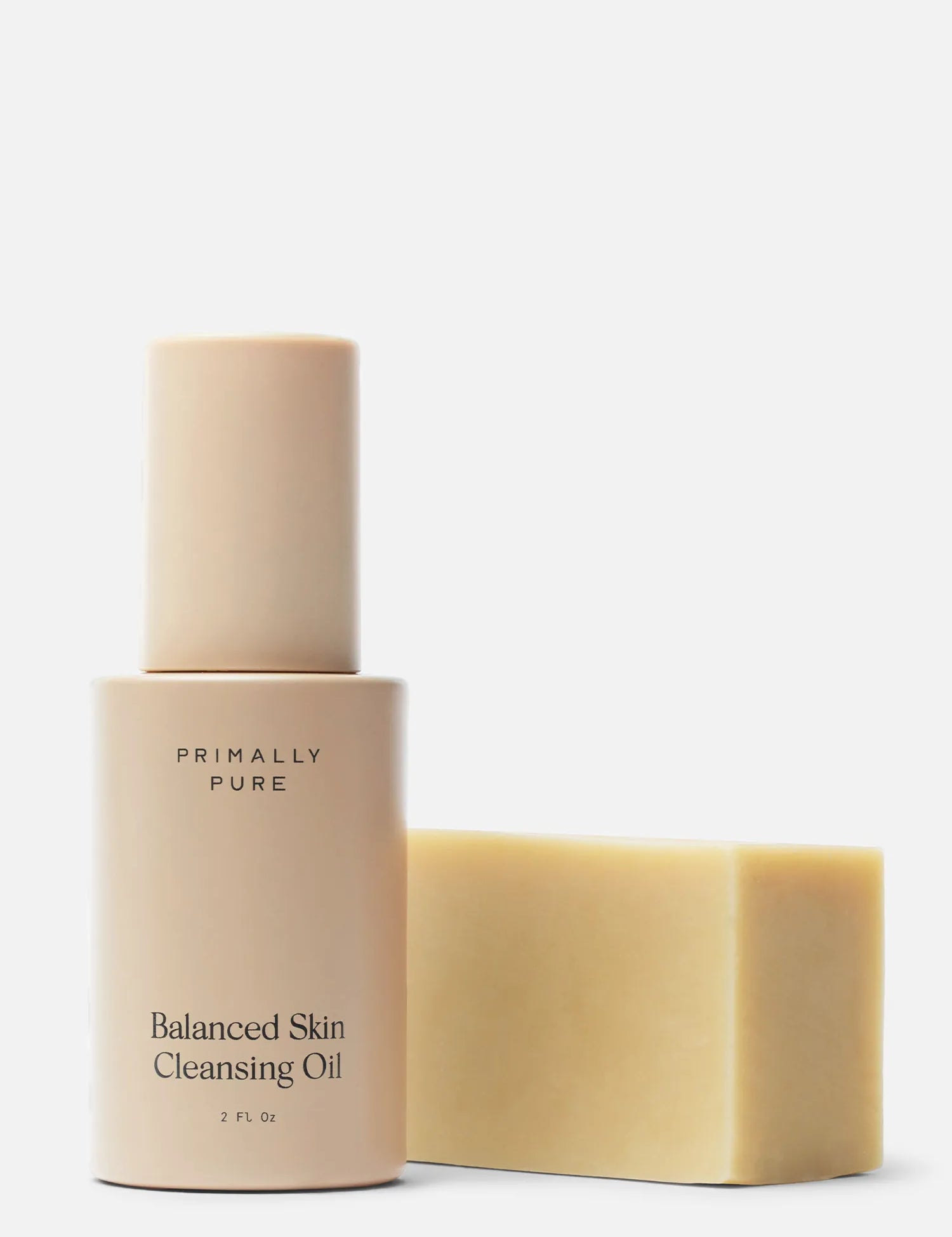Primally Pure Balanced Skin Cleansing Oil bottle in a warm beige tone next to a Baby Bar solid bar of soap on a clean white background. Double Cleansing Kit (Baby Bar) Bundle Primally Pure