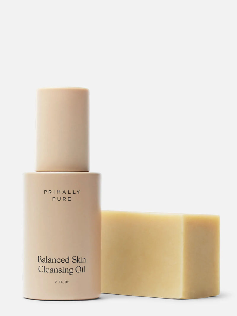 Primally Pure Balanced Skin Cleansing Oil bottle in a warm beige tone next to a Baby Bar solid bar of soap on a clean white background. Double Cleansing Kit (Baby Bar) Bundle Primally Pure