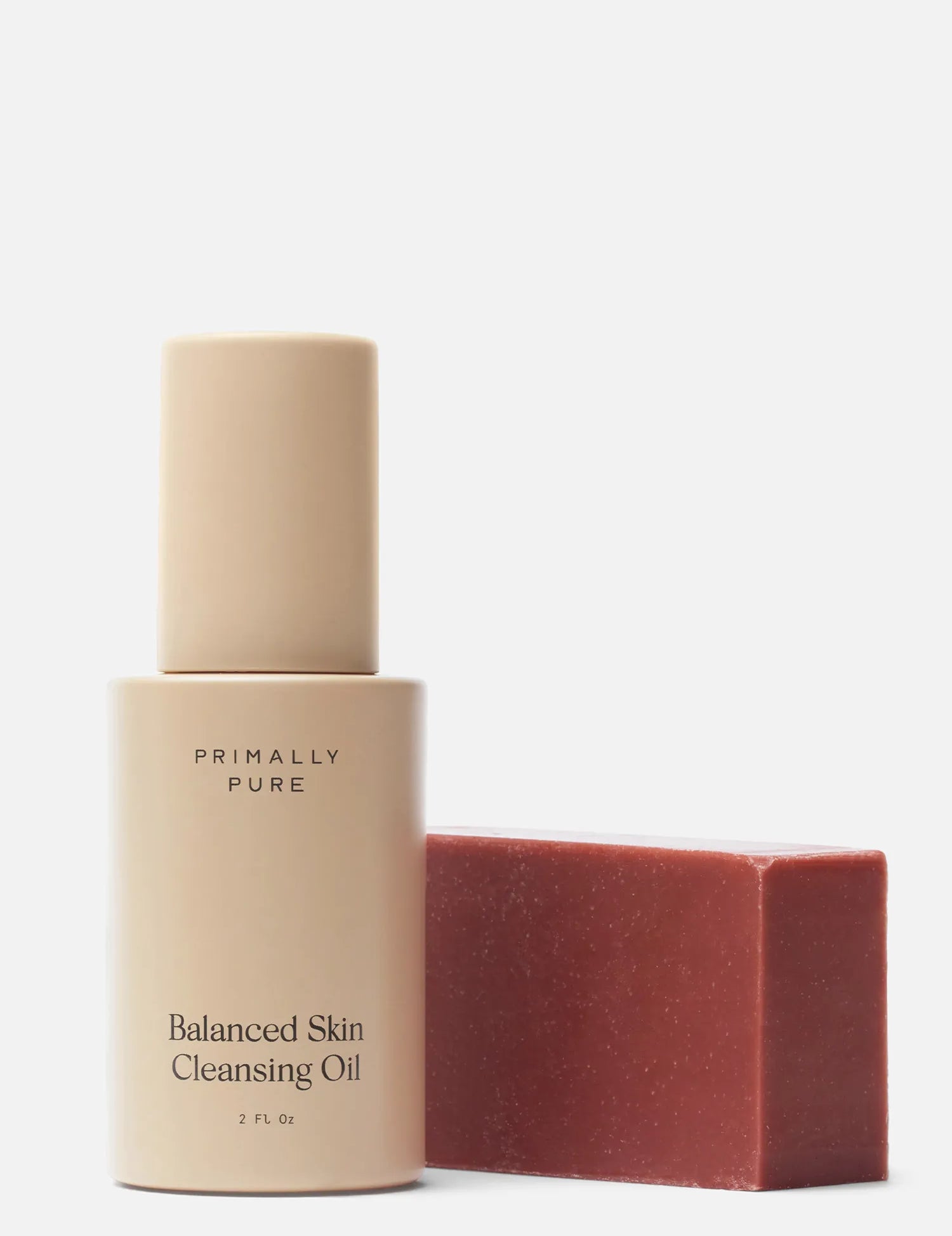 Primally Pure Double Cleansing Kit (Plumping) Bundle in a warm beige tone next to a red rectangular bar Plumping Bar Face Soap Bar, on a clean white background.