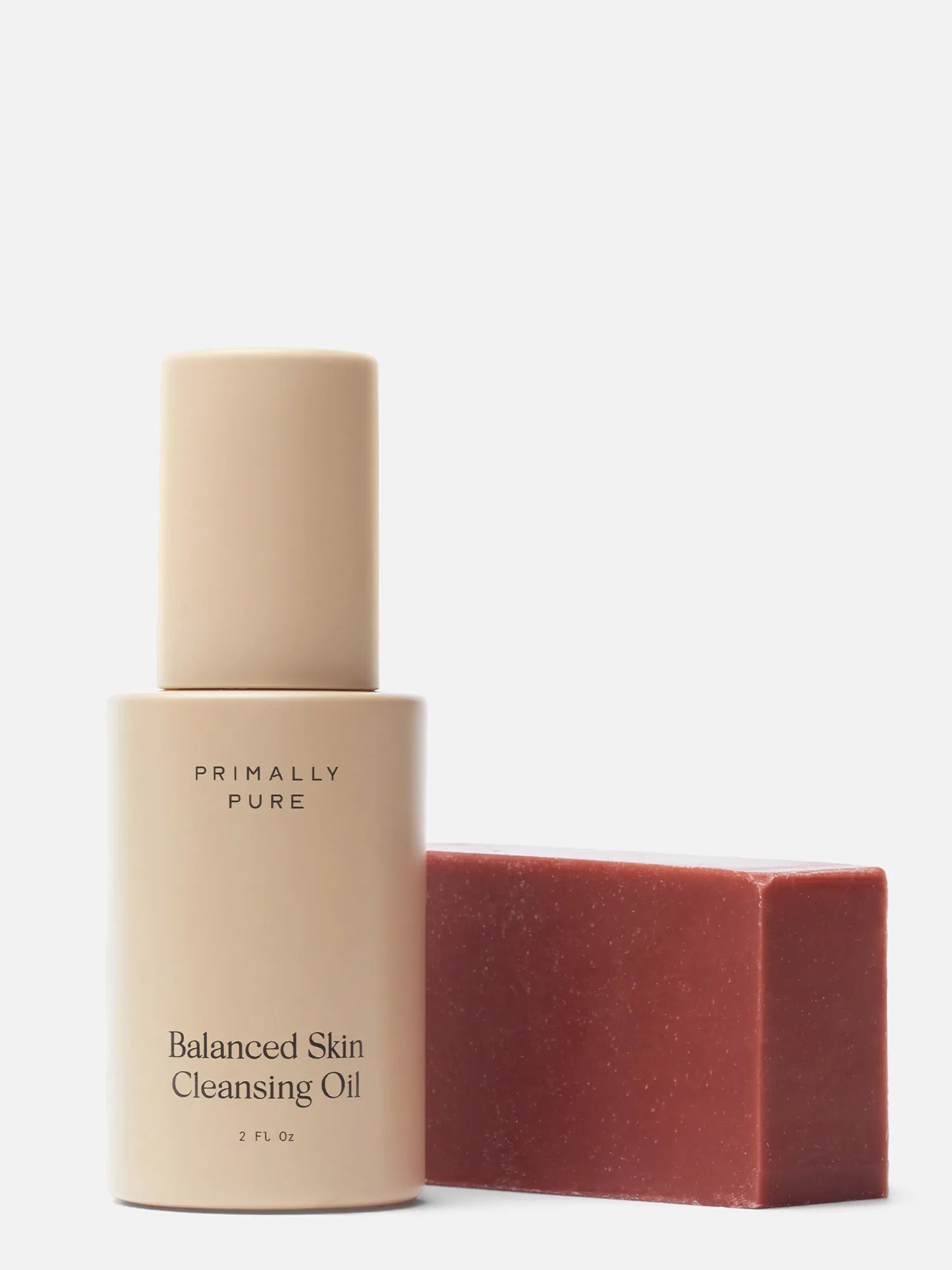 Primally Pure Double Cleansing Kit (Plumping) Bundle in a warm beige tone next to a red rectangular bar Plumping Bar Face Soap Bar, on a clean white background.