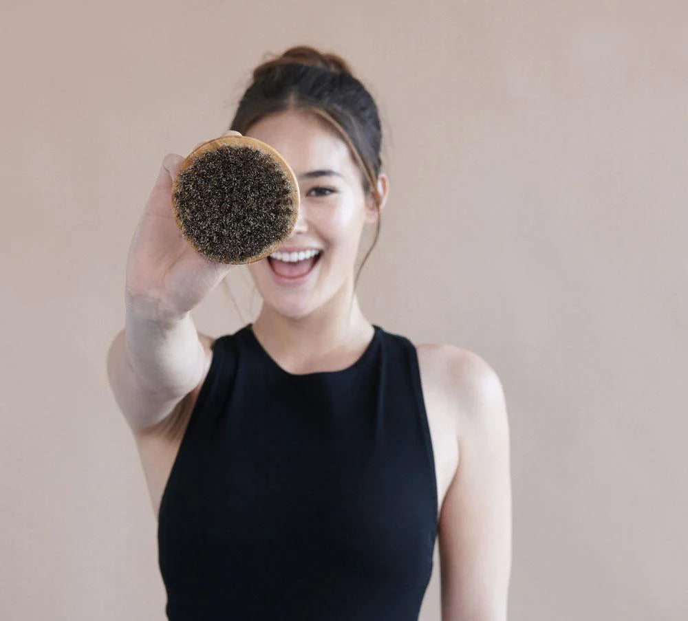 Woman holding up a dry brush