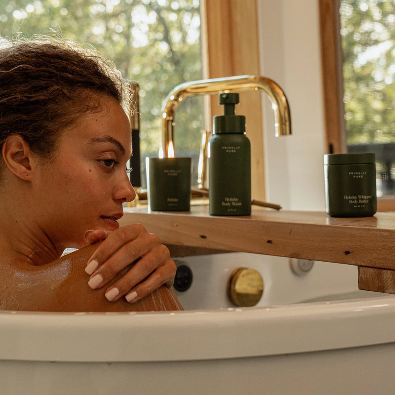 Woman applying Primally Pure Holiday Body Wash to arm