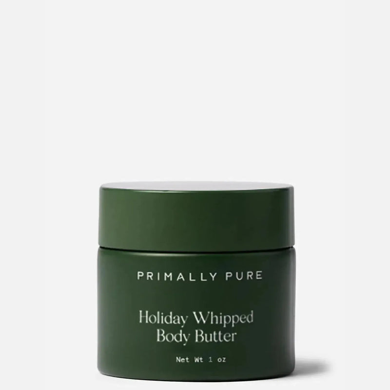Primally Pure Holiday Whipped Body Butter in a dark green jar with a matching lid, set against a light gray background.