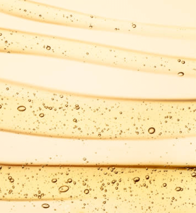 Close-up of emu oil with a smooth golden texture and small air bubbles