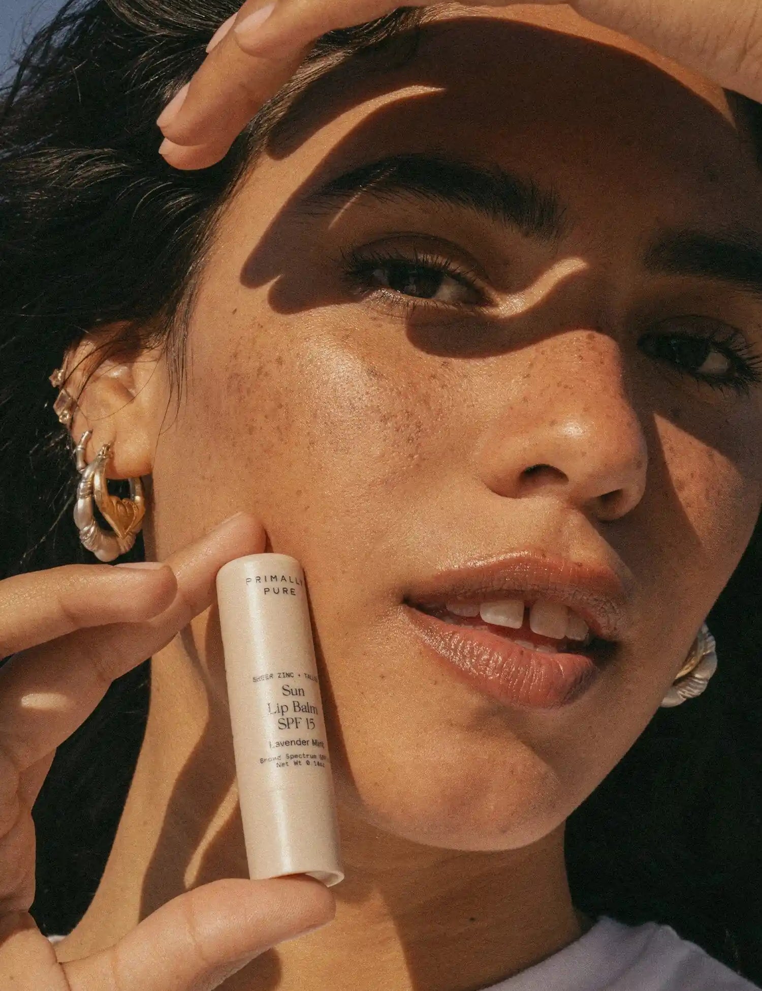 Sun Lip Balm SPF 15 Sunscreen Primally Pure Model holding Mineral SPF Lip Balm - Tallow sunscreen