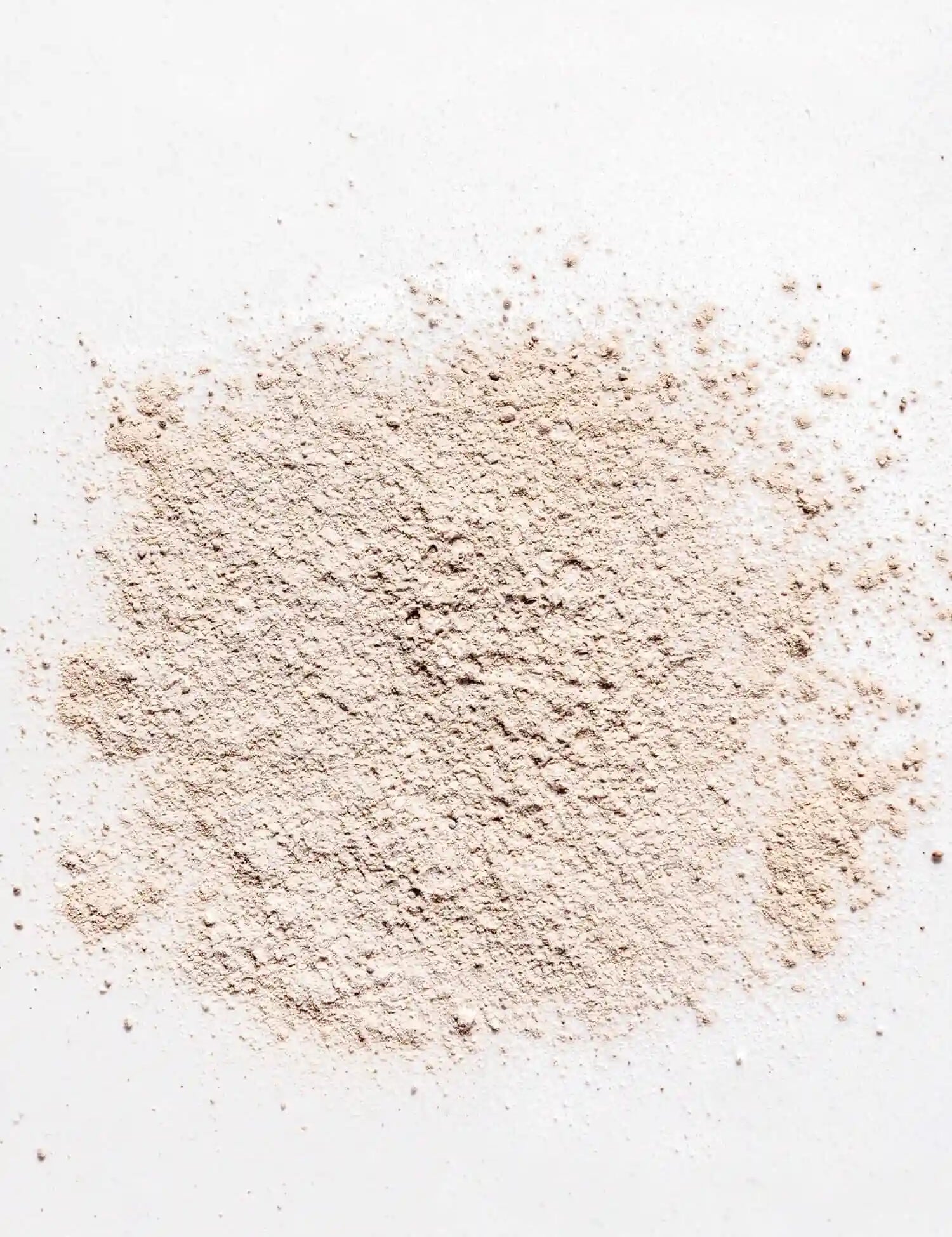 Powdered non-toxic dry shampoo on a white background, perfect for natural hair care from Primally Pure.