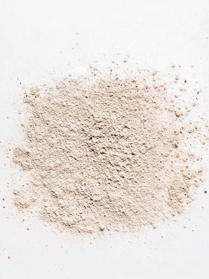 Powdered non-toxic dry shampoo on a white background, perfect for natural hair care from Primally Pure.