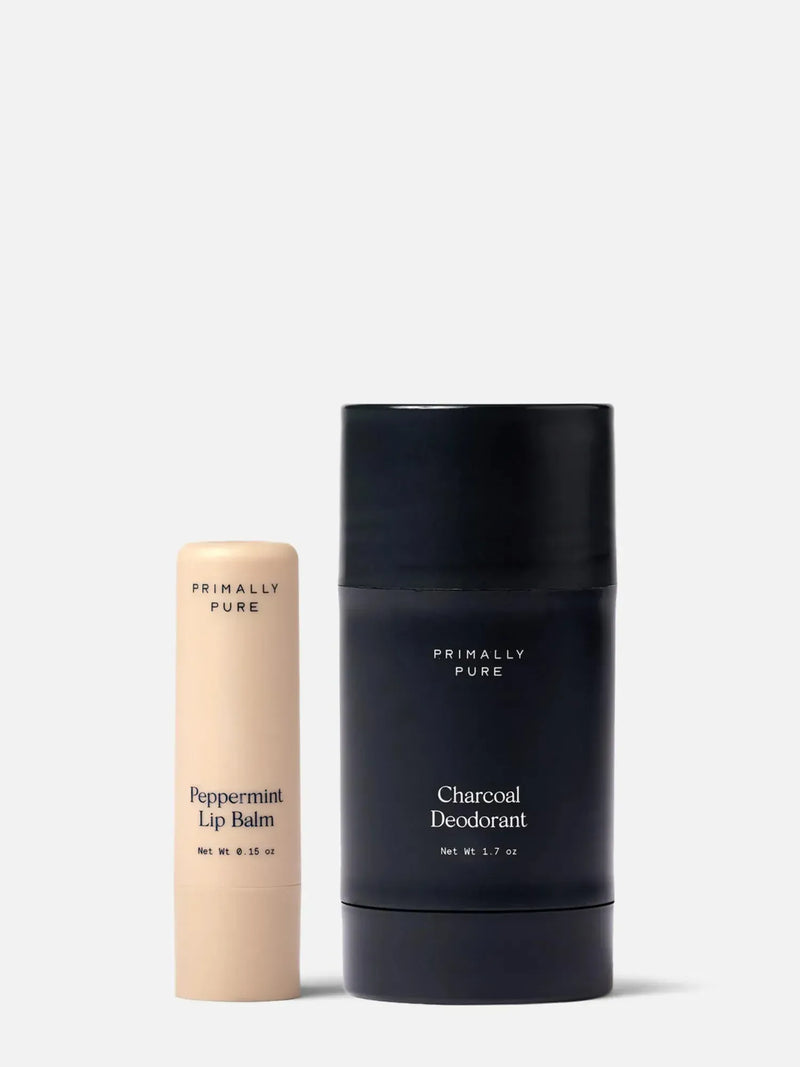 Primally Pure Peppermint Lip Balm and Charcoal Deodorant on a white background