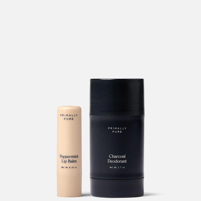 Primally Pure Peppermint Lip Balm and Charcoal Deodorant set on a clean white background. The Lips + Pits Starter Bundle with 2 Primally Pure Best-Selling Products.