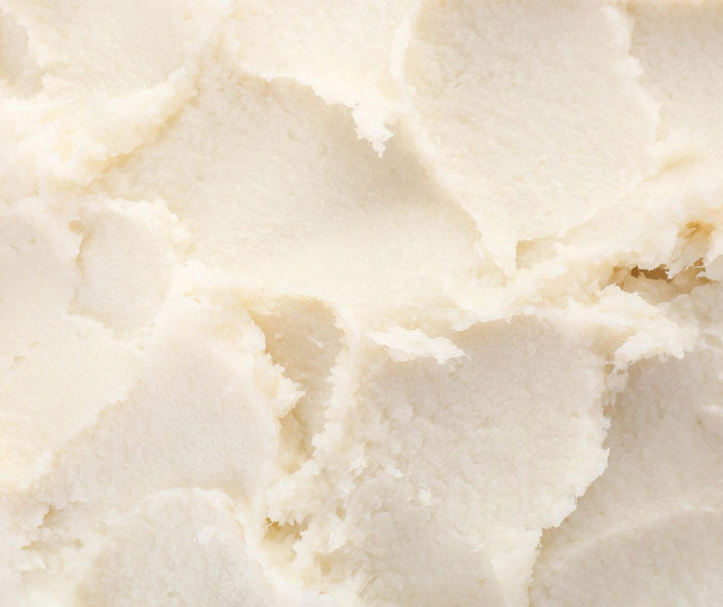 Close-up of smooth mango butter texture used in skincare products.