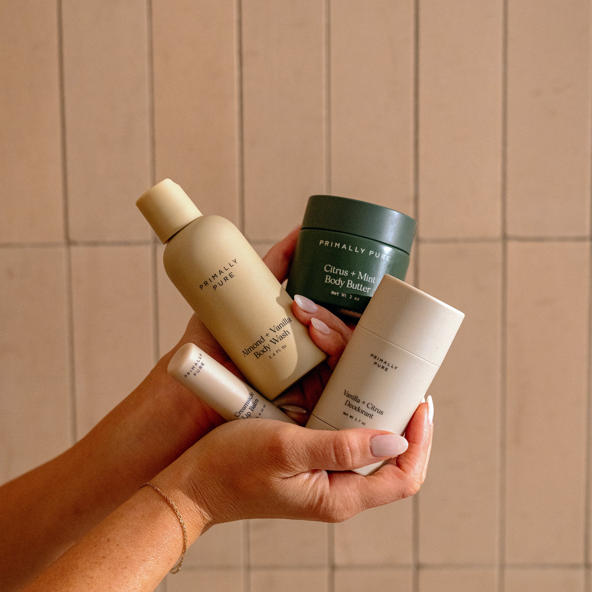 Woman holding Primally Pure products included in The Jet Set bundle