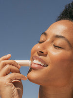 Sun Lip Balm SPF 15 Sunscreen Primally Pure Model Using Mineral SPF Lip Balm