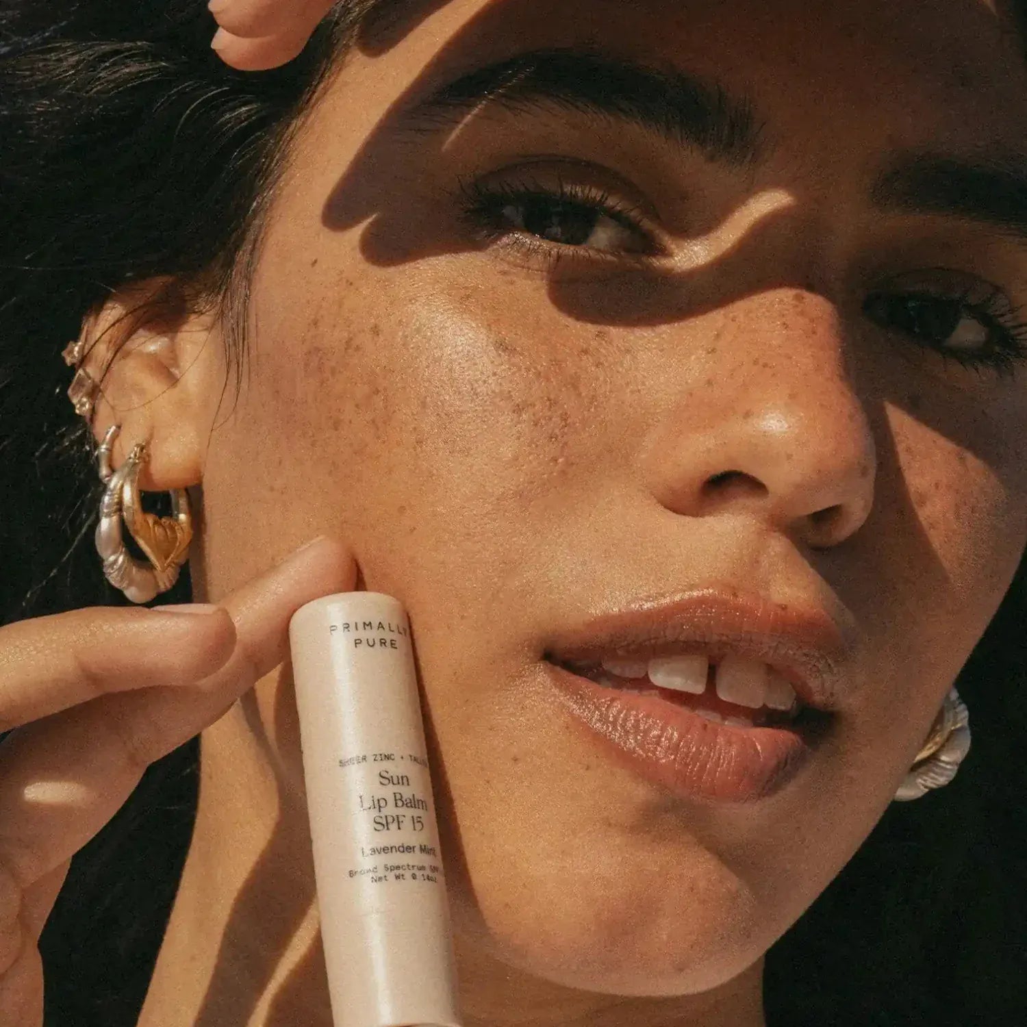 Sun Lip Balm SPF 15 Sunscreen Primally Pure Model holding Mineral SPF Lip Balm - Tallow sunscreen