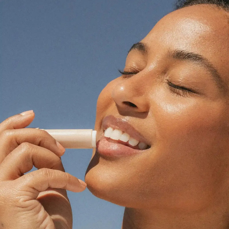 Sun Lip Balm SPF 15 Sunscreen Primally Pure Model Using Mineral SPF Lip Balm