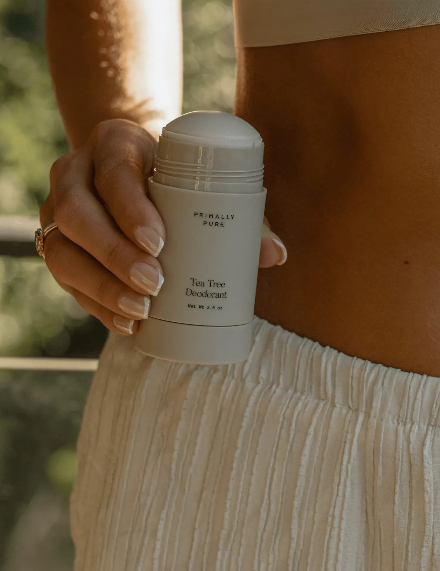 Woman holding Tea Tree Deodorant Deodorant Primally Pure - Natural deodorant - 40,000 5-star reviews