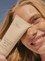 Sun Cream SPF 30 Sunscreen Primally Pure Model Holding Organic Sun Cream